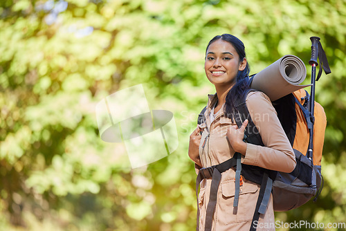 Image of Hiking, portrait and fit woman backpacking in nature for fitness, strength and adventure. Backpacker, hiker and face of a female sportwoman exploring in a forest for fresh air and trekking peace