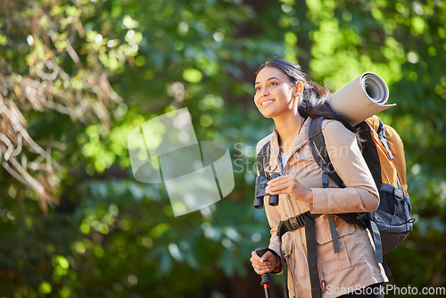 Image of Woman, happy hiking and nature with backpack, trees or binocular in sunshine on forest journey. Hiker girl, smile and summer camping in woods, outdoor freedom or trekking on dream adventure in Amazon