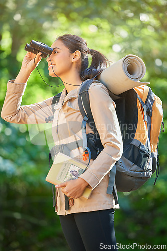 Image of Adventure, hiking and woman trekking in nature, bird watching and search in the forest of Taiwan. Travel, smile and girl with binoculars to check for birds while on a walking holiday in a jungle