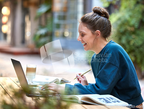 Image of Woman, laptop and student study at cafe with smile for education, learning or writing in the outdoors. Happy female at internet coffee shop in remote working or elearning on computer for assignment