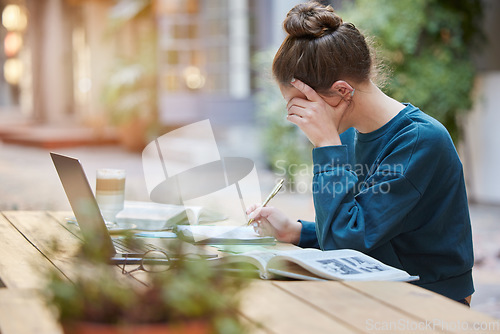 Image of Woman, student and writing in study for elearning, education or working with laptop and books at an outdoor coffee shop. Focused female studying remote with notebook for assignment at outdoor cafe