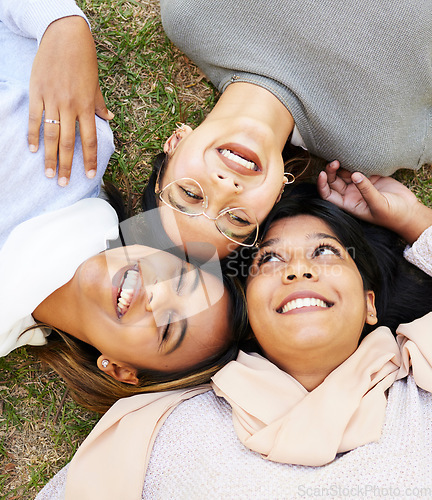 Image of Friends, happy and relax with laugh, face and enjoy fun quality time together in outdoor nature park. Grass floor, top view and face of happy women smile and support on holiday in Miami, florida