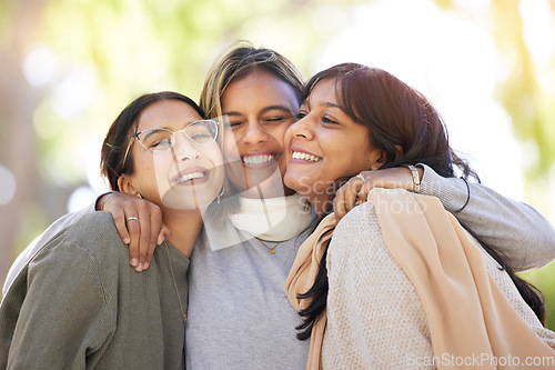 Image of Women friends, hug and smile in park for happiness, support and relax in sunshine at best friends reunion. Woman group, happy and love embrace with care, nature and blurred background in Los Angeles