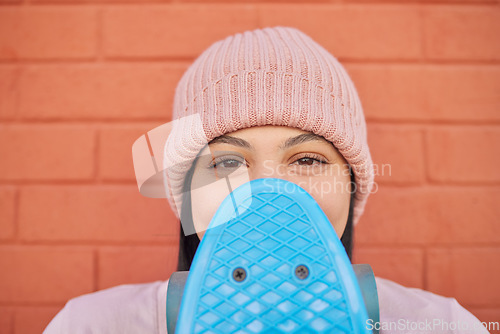 Image of Woman, face or skateboard on orange wall background in city in fashion, Brazil trendy or cool clothing, hat or beanie head wear. Portrait, happy or skateboarder student or freedom vision or fun ideas