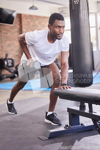 Image of Gym, black man and dumbbell training, rowing exercise and healthy workout in fitness club. Strong bodybuilder guy row with weights, motivation and energy for sports, muscle power and body wellness