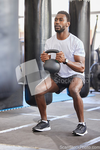 Image of Black man, gym and kettlebell for squat exercise, weightlifting workout or muscle growth training. African bodybuilder, wellness trainer and metal weights for strong legs, body development or health