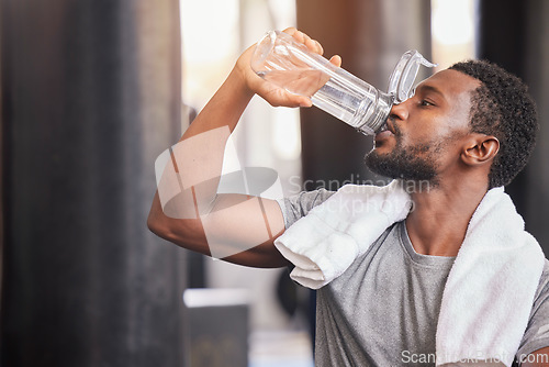 Image of Fitness, drinking water and relax with black man in gym for training, endurance and workout. Energy, focus and sweat with athlete bodybuilder cooling down in club for sports, exercise and cardio