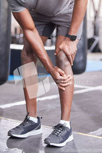 Image of Fitness, injury and knee pain of black man at gym with inflammation problem resting legs. Joint pain, accident and cardio exercise person injured training at health club trauma assessment.