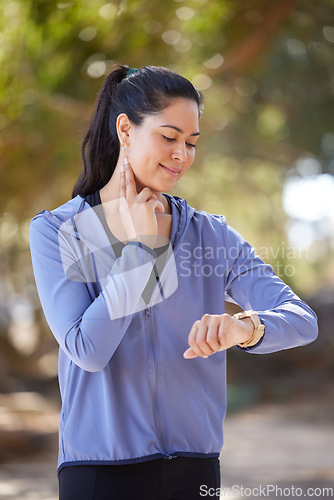 Image of Smartwatch, fitness and woman pulse after running in the park, on a break to check heart rate on. Happy girl doing exercise, training and workout in nature for wellness, cardio and healthy lifestyle