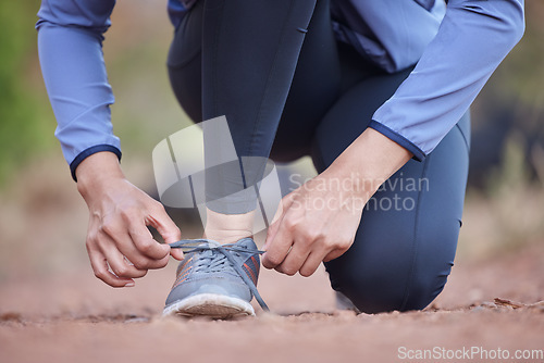 Image of Start, running and feet of a woman in nature, training motivation and cardio fitness in Colombia. Ready, shoes and hands of an athlete tying laces for workout, exercise or hiking in a park for health