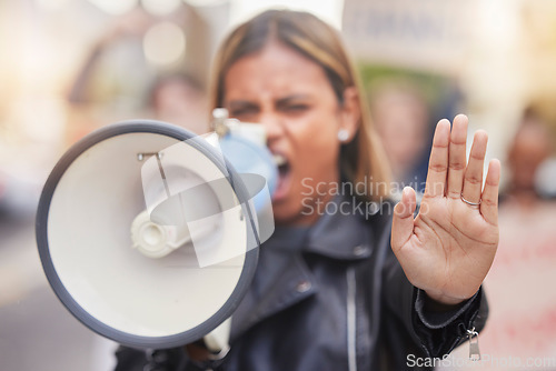 Image of Woman, megaphone and hand in protest to stop gender based violence, discrimination or equality in the city. Angry female activist shouting, protesting or announcement for human rights or awareness