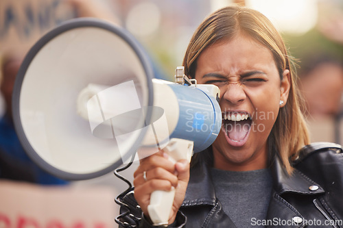 Image of Megaphone, woman and shouting for social change, humanity and justice for equality, on street and stand up. Young female, protester and Hispanic girl with bullhorn, protesting for freedom and strike