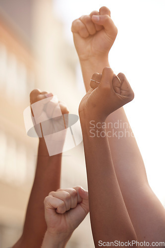 Image of Hands fist and justice of power by people in protest for freedom, equality and change in a street. Community, action and government rally by man and woman in solidarity for society democracy