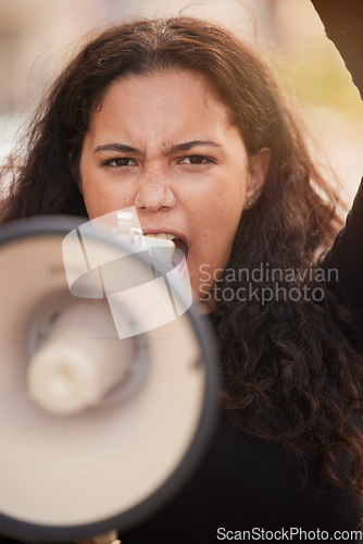 Image of Woman, megaphone and protest in the city for human rights, gender based violence or equality in the outdoors. Female activist shouting, screaming and speaker for discrimination, community or change