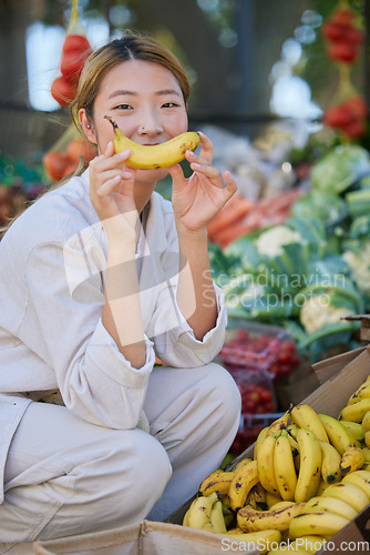 Image of Asian woman, portrait and fruit or vegetable market outdoor for grocery shopping, food supermarket and happy customer with banana. Nutrition, grocery store fruits and happiness for healthy eating