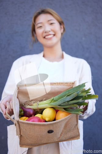 Image of Grocery shopping, vegetables and woman with a bag in the city, supermarket food and happy with sale from the fruit store. Produce, smile and Asian girl show groceries with nutrition for diet