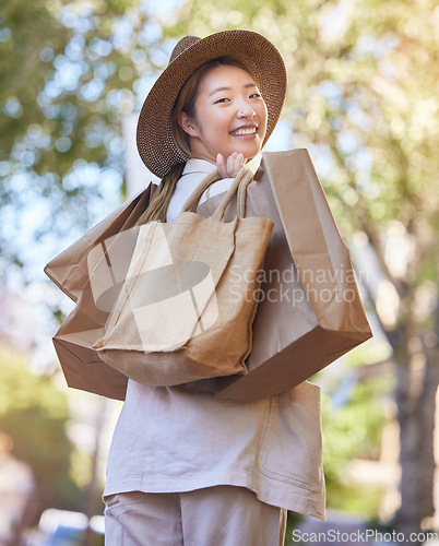 Image of Shopping, street and woman portrait from Japan happy about retail sales and fashion deal. Sale, walking and Asian person with happiness and store bags with a smile from mall promotion and discount