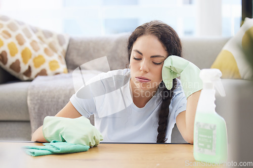 Image of Tired woman, cleaning and burnout with cloth, detergent and latex gloves for housework or hygiene at home. Exhausted female domestic relaxing by table on a break from housekeeping or sanitary work