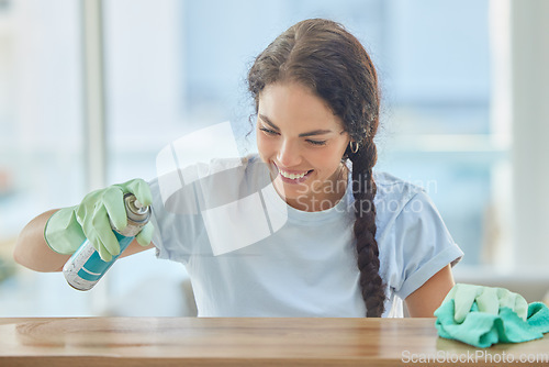 Image of Cleaning, table and happy woman spray with cloth for dirt, dust or bacteria on furniture at home. Happy cleaner, housekeeping and maid wipe wood surface, maintenance care and spring cleaning services