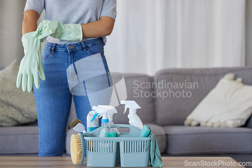 Image of Black woman hands for cleaning, product in basket on table for home maintenance tools or living room spring cleaning. Cleaner, container or maid with brush or liquid spray bottle for cleaning service