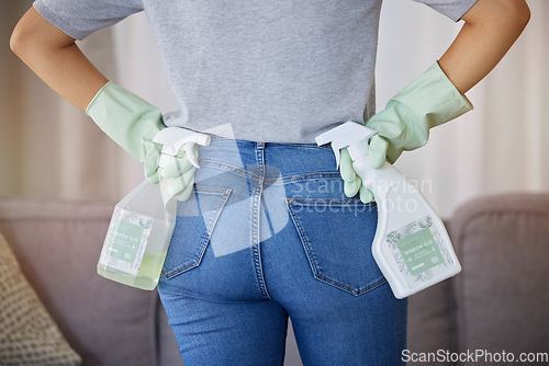 Image of Cleaning, housework and woman from back with spray bottle and gloves in in living room at home. Spring cleaning, hygiene and bottle of soap or sanitizer to clean dirty sofa, housekeeper in apartment.