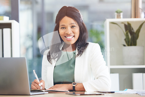 Image of Office, portrait and black woman writing in notebook for business schedule, time management and calendar in Human Resources. Face of an HR corporate worker at her desk on laptop for career excellence