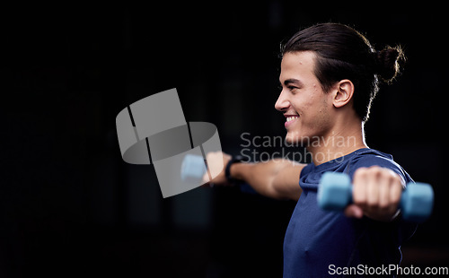 Image of Man, fitness and dumbbells with smile by black background for health, wellness or muscle development. Happy young bodybuilder, weightlifting or workout for strong arms, training or exercise in studio