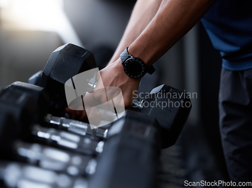 Image of Fitness, dumbbell and hands of man at gym with smart watch for training, tracker or workout app. Strong, muscle and weightlifting with wearable tech on bodybuilder for sport, exercise or goal