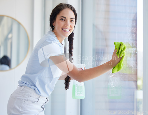 Image of Woman, cleaning window and spray in portrait with smile, cloth and bottle for hygiene, shine and work. Expert cleaner, hospitality worker and chemical for clean glass, spring cleaning and stop dirt