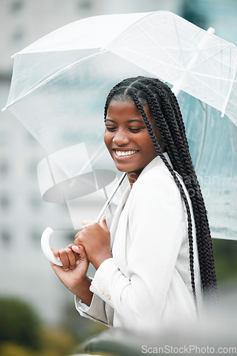 Image of Stylish, trendy woman with an umbrella in the city for insurance on a cold winter day. Rain, weather and elegant female with style covering herself in an urban town in a fashionable jacket