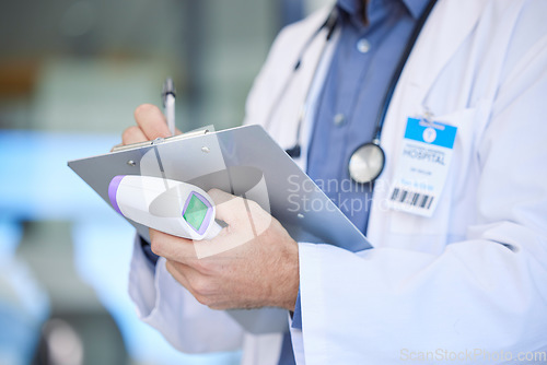Image of Doctor hands writing, clipboard and thermometer in hospital to record symptoms, results or information. Covid, checklist and man or medical physician write notes on documents for research in clinic.