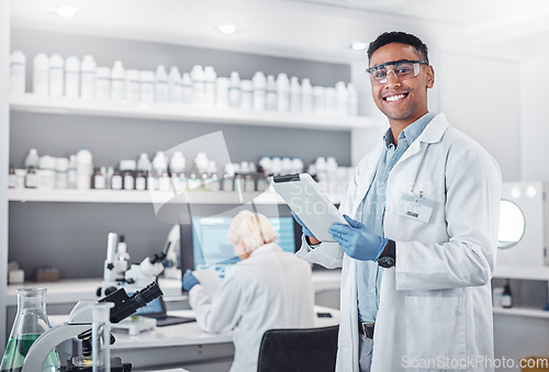 Image of Science, tablet and portrait of a male scientist doing research with technology in a medical laboratory. Happy, smile and man chemist or biologist working on a mobile device in a pharmaceutical lab.