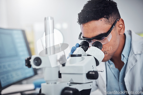 Image of Science, microscope and man in laboratory for research, testing or medical analysis. Healthcare innovation, scientist and male doctor with equipment to check sample, studying particles or bacteria.