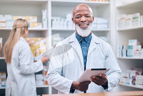 Image of Portrait, pharmacist or black man with a tablet for healthcare research or medicine list at a drug store or pharmacy clinic. Face, doctor or happy senior worker smiles with pride, goals or trust