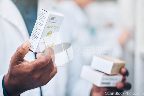 Image of Pharmacy, black man and hand of pharmacist with medicine boxes. Pills, medication and male medical professional with drugs for prescription, healthcare and wellness, cure or treatment in drug store.