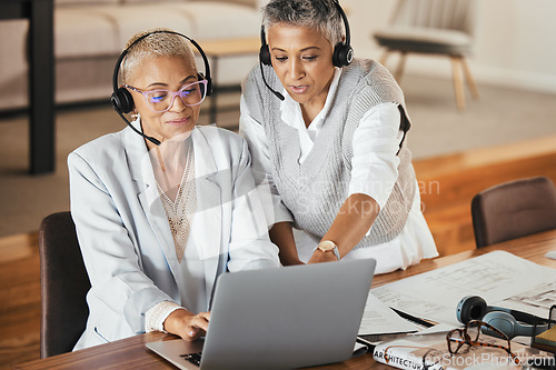 Image of Customer support, call center and manager helping consultant with an online consultation in the office. Customer service, telemarketing and senior leader consulting agent on laptop in the workplace.