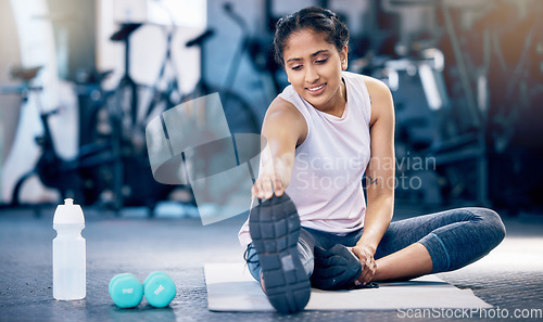 Image of Stretching, fitness and water bottle with woman in gym for weightlifting, exercise and sports training. Challenge, wellness and workout with girl athlete and warm up for start, strong and cardio