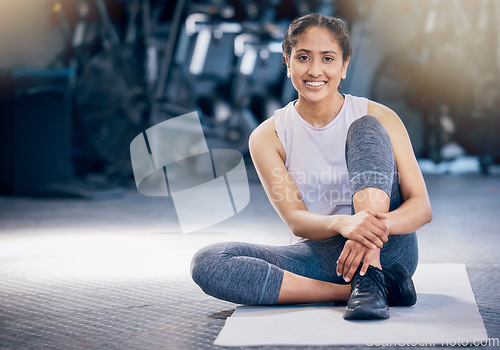 Image of Woman, portrait and gym with smile for fitness, wellness and health goals on floor with happiness. Happy personal trainer, flooring and vision for workout, training goal and exercise in Los Angeles