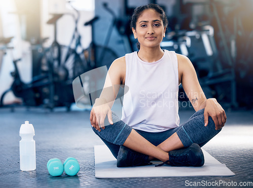 Image of Woman, crossed legs or stretching on gym mat in healthcare wellness, muscle pain relief or fitness flexibility. Portrait, happy sports athlete or personal trainer in pilates, workout or training club