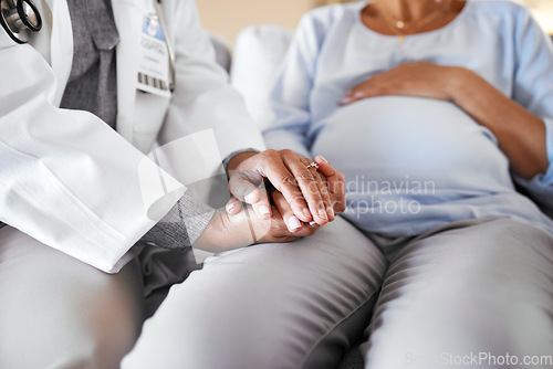 Image of Healthcare, doctor sitting and holding hands with pregnant woman on sofa for care, trust and support in medicine. Gynecologist, woman and pregnancy, helping hands encourage new mother with empathy.