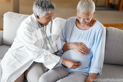 Image of Pregnant, consulting and doctor with woman on a sofa for medical checkup, health and exam during home visit. Healthcare, pregnancy and senior ivf fertility expert doing wellness check in hospital