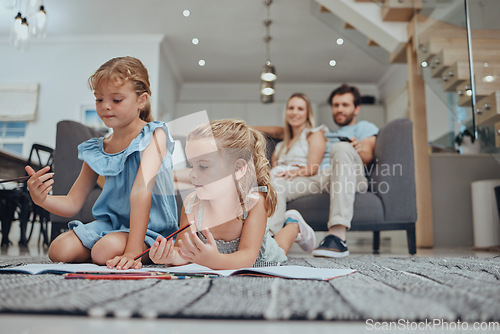 Image of Relax, children drawing and parents on sofa in the living room bonding, resting and watching the kids. Education, family and girls doing homework on the floor with mother and father sitting on couch.