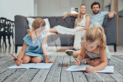 Image of Living room, parents relaxing and children drawing in books on the floor in their modern home. Mother, father and girl kids sitting in the lounge together to rest, draw and bond in their house.