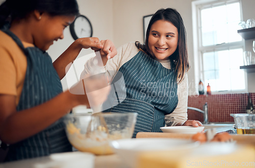 Image of Mom, girl and cooking with learning, motivation and teaching for cookies, bonding and care in home kitchen. Baking, mother and daughter with celebration, teamwork and fist bump with love in Toronto