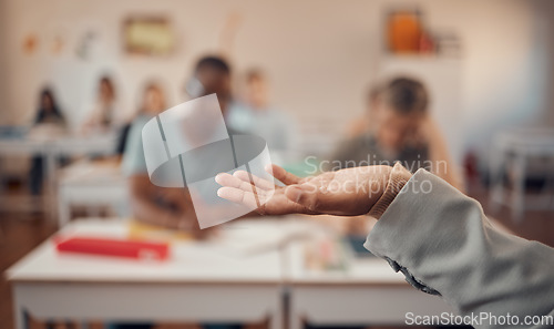 Image of Hand, education and study with a teacher and students in a classroom for a lesson on growth or development. University, learning and higher education with an educator explaining a theory in a class