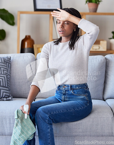 Image of Headache, cleaning woman and tired person at home after spring clean and living room dust. House, black woman and sad cleaner feeling stress and sad from spring cleaning with spray and cloth on sofa