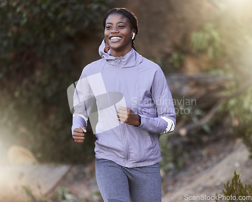 Image of Black woman, running and outdoor for exercise, training or fitness for health, wellness or smile. Jamaican female, healthy athlete or runner in nature, workout or practice for power, energy or cardio