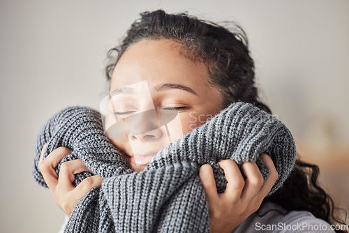 Image of Happy, woman and fresh laundry in home with satisfied smile on face feeling clean wool sweater. Happiness, wellness and hygiene of girl cleaning in laundry room at house touching soft texture.