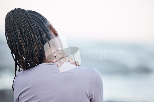 Image of Back, black woman and neck pain with stress, injury and chronic pain. Jamaican female, lady and athlete with tension in the shoulders, muscle strain and massage for healthcare, wellness or overworked