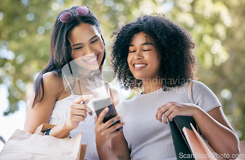 Image of Black woman, shopping and friends with smartphone outdoors for social media retail sales, discount and online fashion deal promo. Planning ecommerce, website shop and browsing internet store together